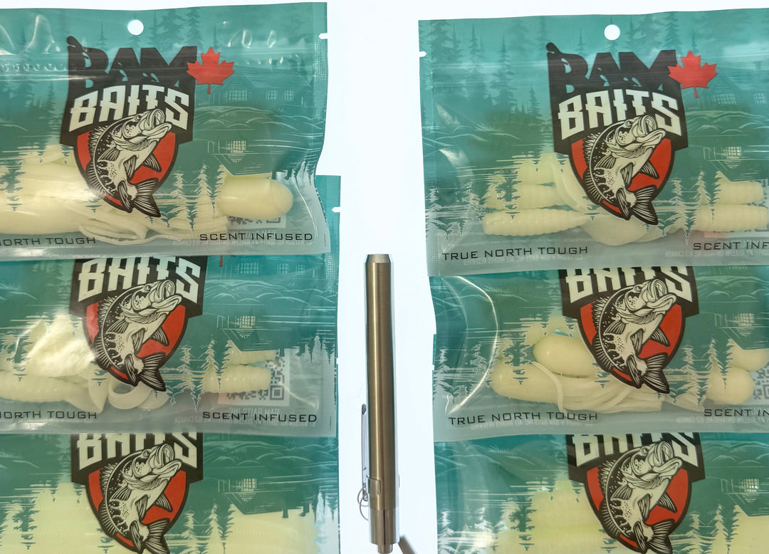 6 packages of BAM Baits with a UV light on a white  background